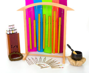 Rainbow scarves and wind chimes, with tuning forks against a white background
