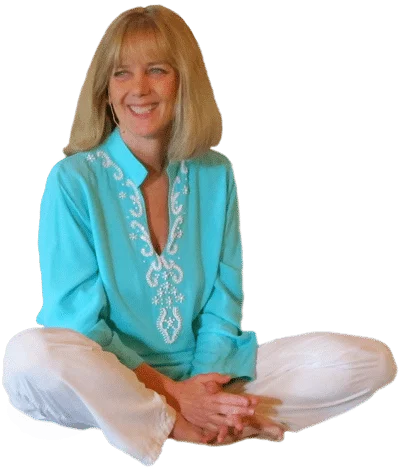 Lady sitting crossed legged, smiling.